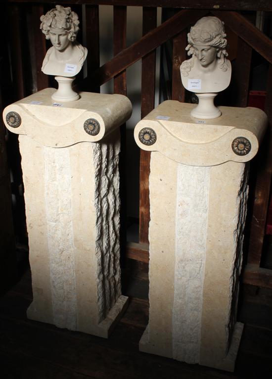 Pair of carved limestone pillars, surmounted by moulded composition classical busts